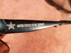 TWO PAIR ADULT UNITED STATES SECRET SERVICE NAME MARKED & USSS LOGOED SUNGLASSES
